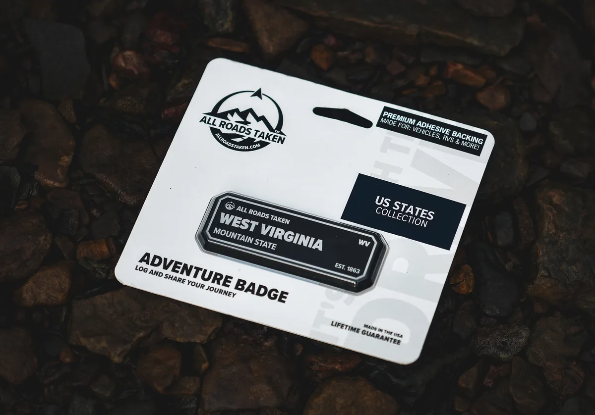 An All Roads Taken West Virginia adventure badge on its retail hang card